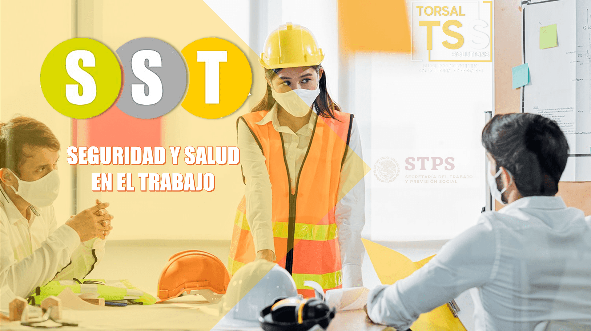 Workers discussing safety and health regulations in the workplace, with safety helmets and documents on the table.