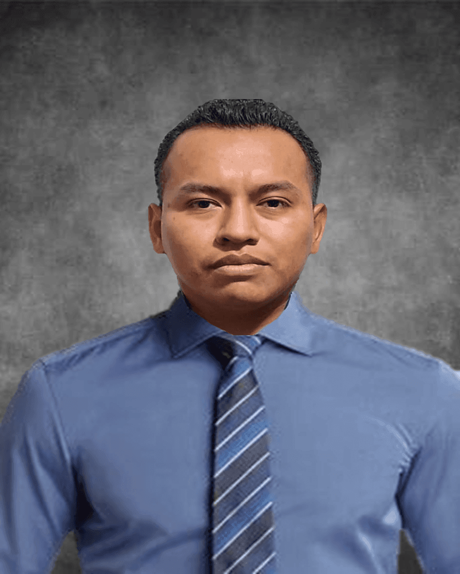 Person wearing a blue dress shirt and striped tie against a textured grey background.